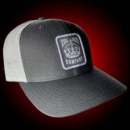 Gray trucker hat with our crown logo on a gray patch. Side view.