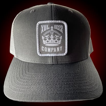 Gray trucker hat with our crown logo on a gray patch. Front view.