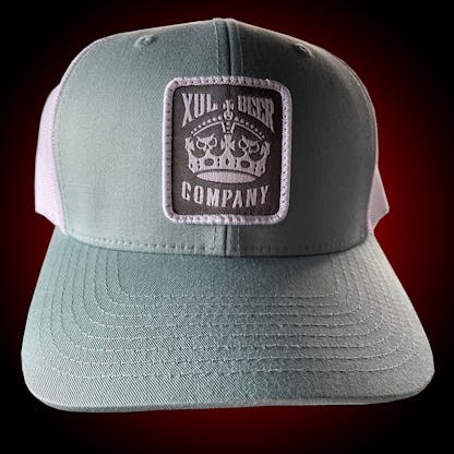 Seafoam trucker hat with our crown logo on a gray patch. Front view