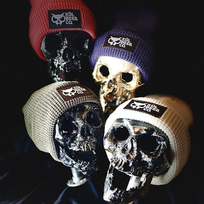 Photo of our beanies in all 4 colors: coral, olive, navy & bone
