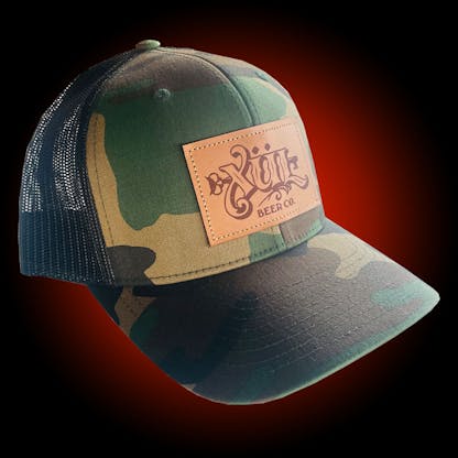Camo trucker hat with our full logo on a brown leather patch