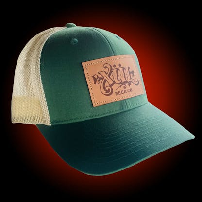 Green trucker hat with our full logo on a brown leather patch