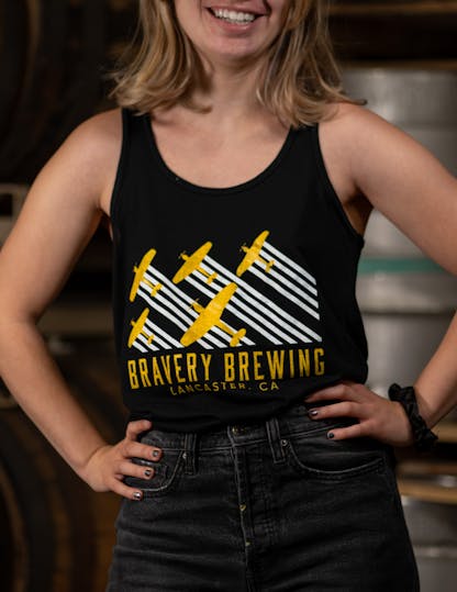 women's black tank top with "Bravery Brewing Lancaster CA" written in yellow letters under a white and yellow airplane design