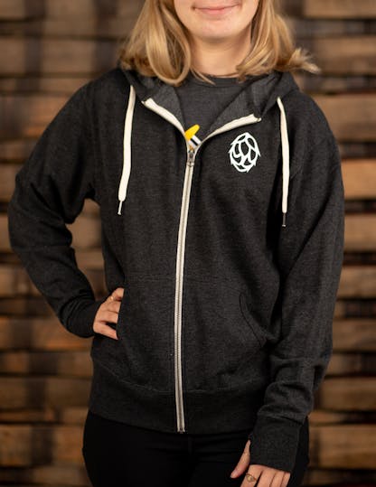dark grey zip-up hoodie with white hop on the front left side