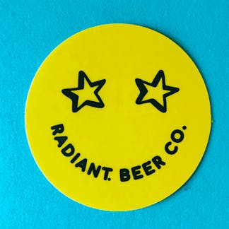 Yellow smiley face sticker with stars for eyes, and "Radiant Beer Co." written as the mouth