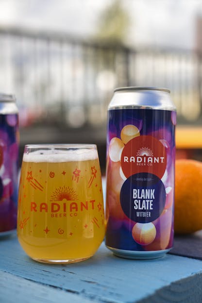 Glass and can of Radiant Beer Co. beer