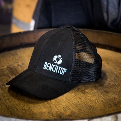 Black suede look hat with teal logo