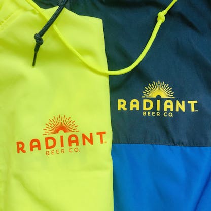 Neon yellow blue windbreaker jackets with Radiant Beer Co. Logo