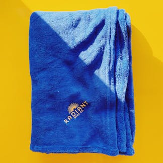 Cozy navy blue blanket with Radiant Beer Co. logo