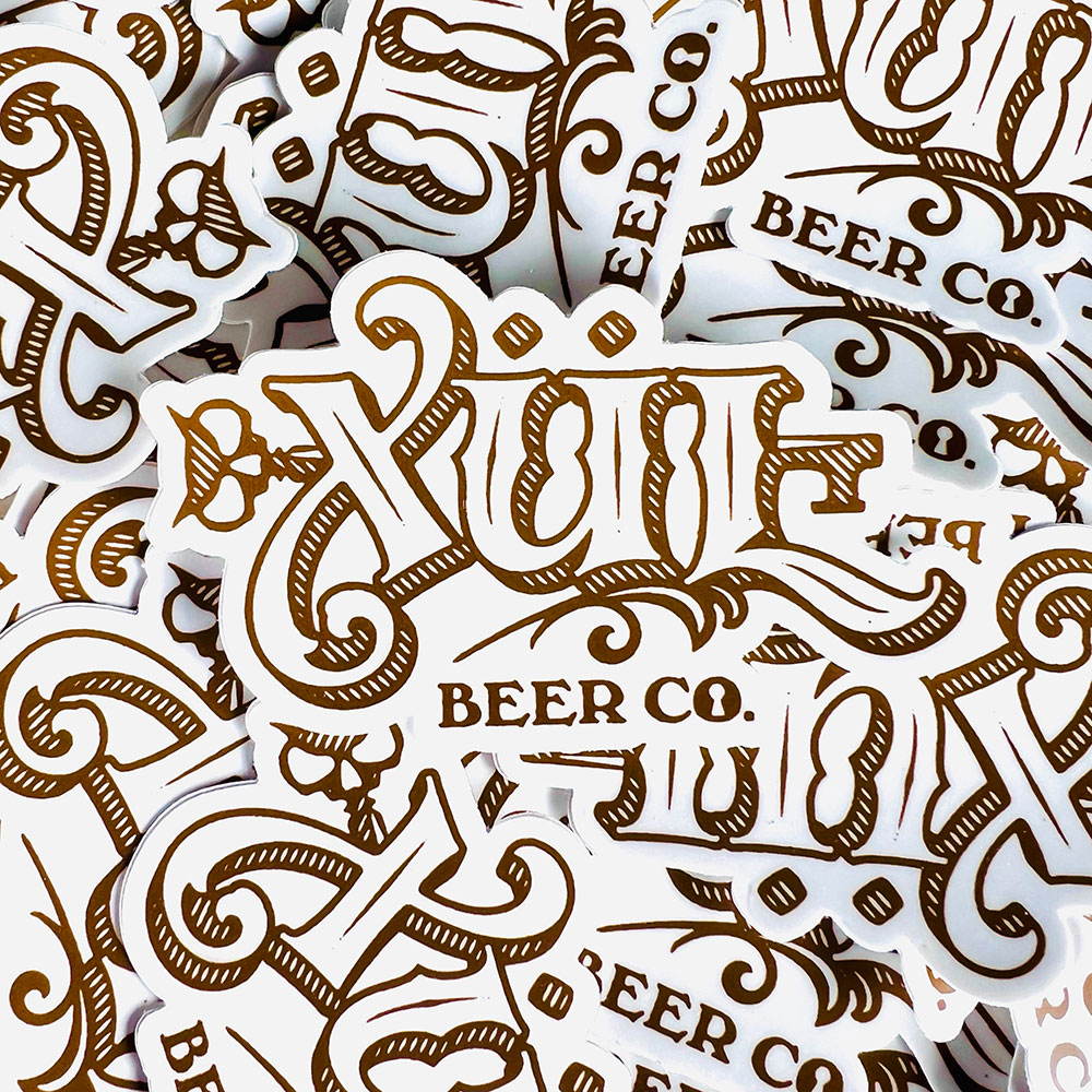 stack of classic logo stickers in white and gold