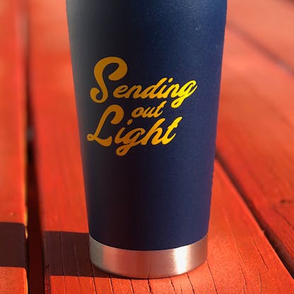 radiant insulated steel pint glass with text, "Sending Out Light"