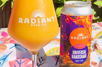 Glass and can of Radiant Beer Co.'s Universal Handshake IPA