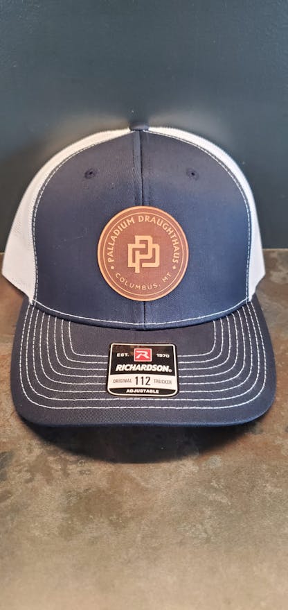 Navy blue and white Richardson 112 cap with leather logo badge