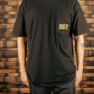 front of a black t-shirt with a pocket on the wearer's left. printed on the pocked is the text "Bravery Brewing Co." in yellow ink.