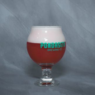 5oz tulip glass filled with red colored beer