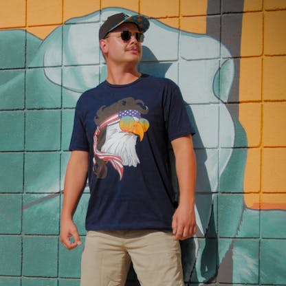 man wearing a navy blue shirt with an eagle with sunglasses on