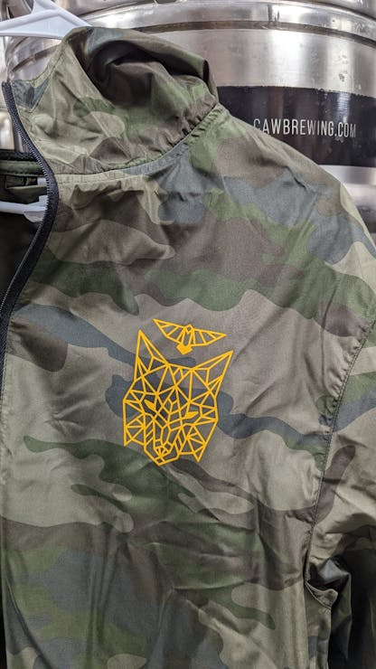 front close up of crow and wolf on camouflage windbreaker