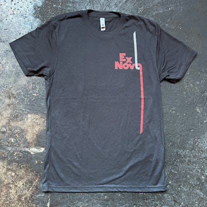 graphite black t-shirt front view on concrete floor with red and white logo text "Ex Novo"