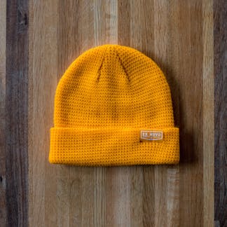 bright yellow waffle knit beanie with clip tag text "Ex Novo Brewing Company"