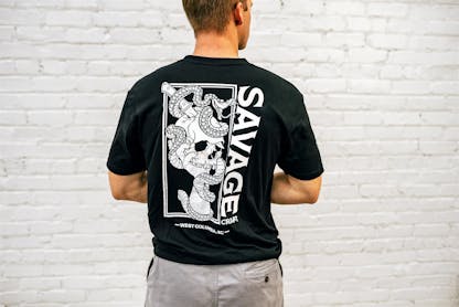 Black short sleeve T-shirt with large white Savage Craft logo on the back