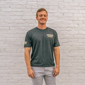 Gray short sleeve T-shirt with "Savage Craft" small logo on front left in gold lettering