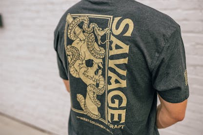 Gray short sleeve T-shirt with large gold Savage Craft logo on the back