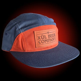 7 panel navy and orange hat with leather logo patch and leather strapback with brass clasp