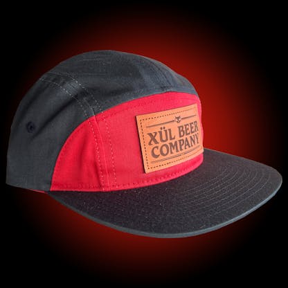 7 panel black and red hat with leather logo patch and leather strapback with brass clasp