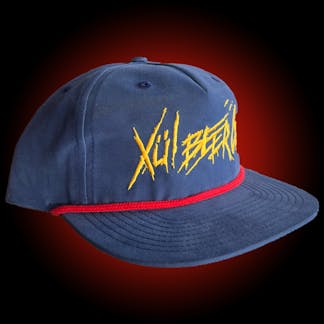 Navy grandpa hat with yellow thrasher Xul logo and red cord.