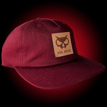 pinch-front 5 panel maroon hat with fanghead on leather patch