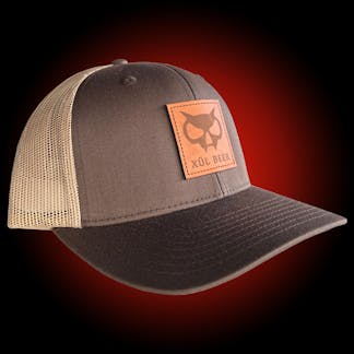 Brown trucker hat with leather fanghead patch