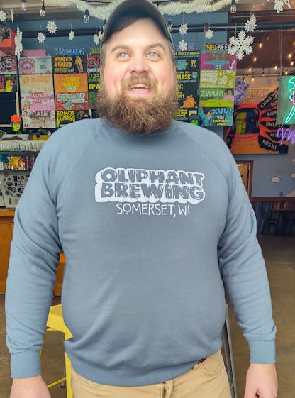 A Man in an Oliphant Brewing Slate Crewneck