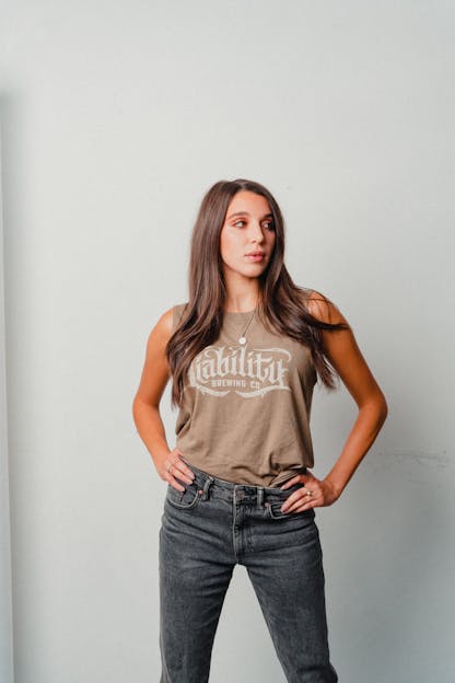 woman wearing olive tank top with Liability Brewing