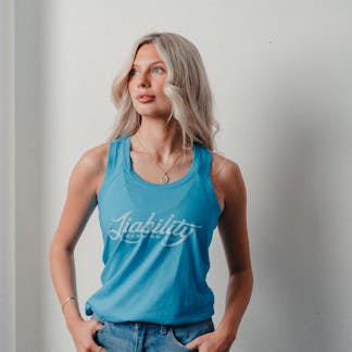 woman wearing a turquoise tank top with Liability Brewing