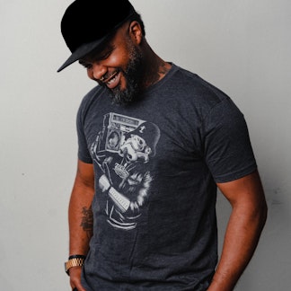 man wearing charcoal shirt with mural