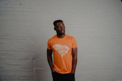 man wearing orange shirt with SC state logo