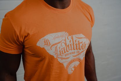 man wearing orange shirt with SC state logo