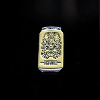 Yellow Tiki sour enamel pin with tiki mask face design on can shaped pin