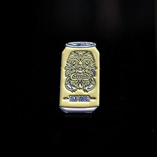 Yellow Tiki sour enamel pin with tiki mask face design on can shaped pin