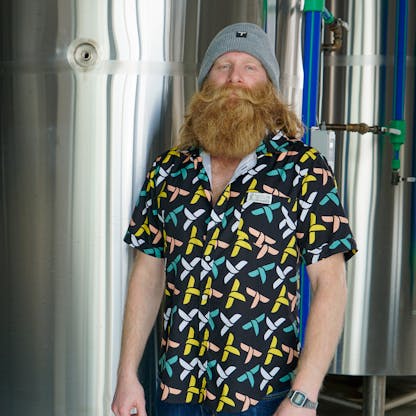Male with a massive beard wearing a teagle pattern party shirt in black and pastel colors.