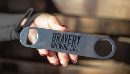 Bravery Bar Blade. The blade is a silver metal with the text "Bravery Brewing Co." printed in black in the center.