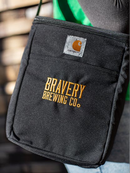 Bravery Carhartt beer cooler. The cooler is black fabric on the outside with the text "Bravery Brewing Co." embroidered in yellow.