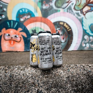Four pack of beer with graffiti characters in background.
