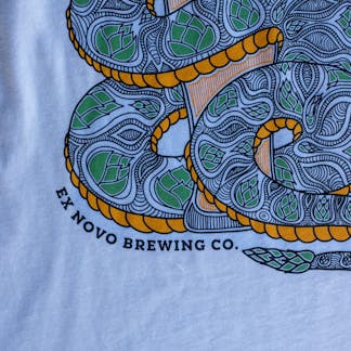 White tank top showing detailed snake with hop pattern on scales wrapped around a pilsner glass