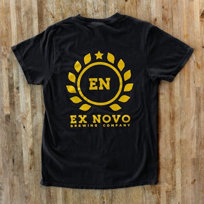 back of Black Cotton T-Shirt with gold line art in circular laurel leaf design with EN text in center and Ex Novo Brewing Company text below