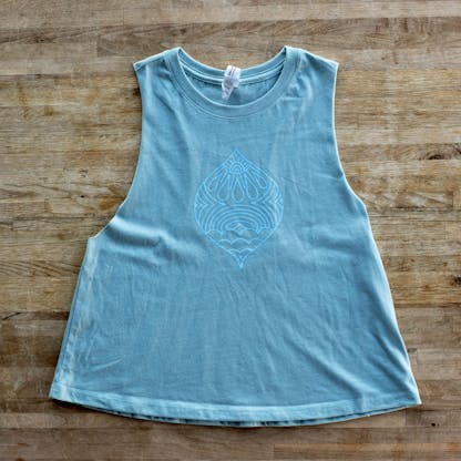 Denim Wash Heather Tank Top laid flat with decorative pattern in a light blue large in the center of the chest