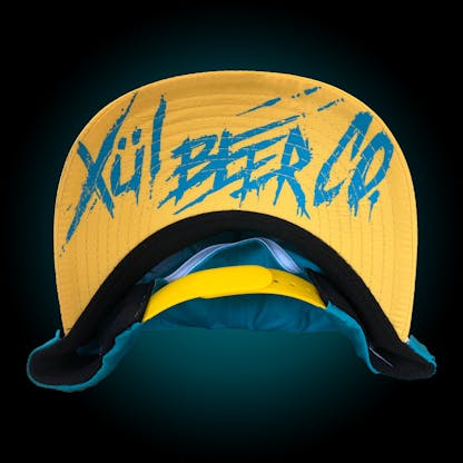 Yellow hat bill with Thrasher logo in teal