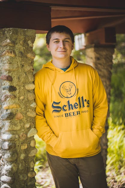 A man wearing a sweatshirt that says  schells