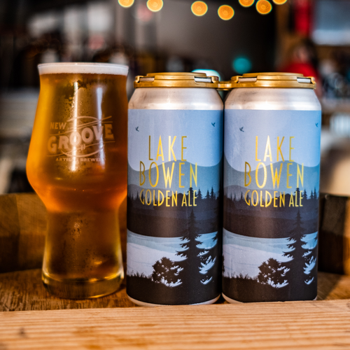 Two cans and one glass filled with beer called lake Bowen 