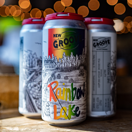 Four pack of Rainbow beer sitting on a table 